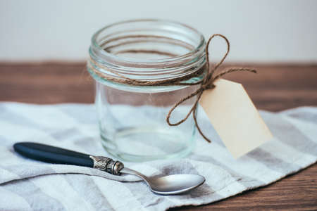 Empty jar with paper label. Blank label provides copy space for a messageの写真素材
