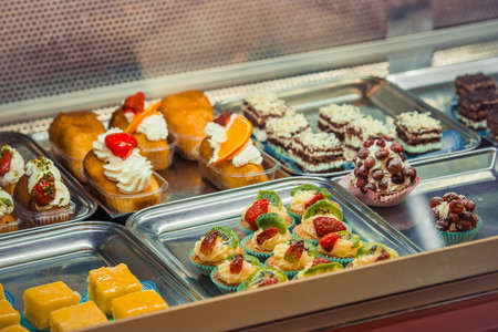 Various pastry type on shelf in bakery shop