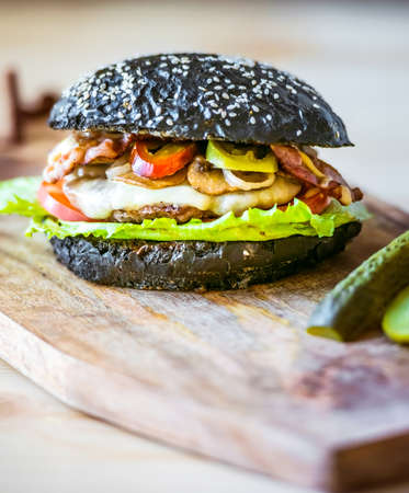 Modern black burger on wooden boardの写真素材