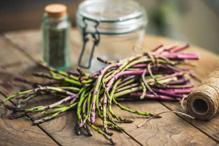 Bunch of fresh asparagus on wooden table. Selected focusの写真素材