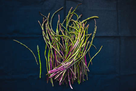 Bunch of fresh asparagus on dark backgroundの写真素材