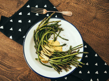 Boiled green asparagus dressed in mustard vinegar and olive oil dressing mayonnaise or hollandaise sauceの写真素材