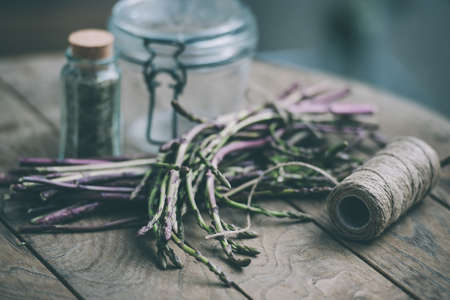 Bunch of fresh asparagus on wooden table. Selected focus and shallow DOF. Toned pictureの写真素材