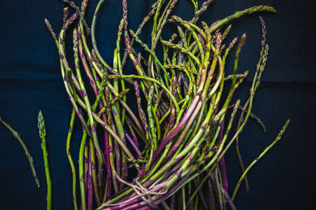 Bunch of fresh asparagus on dark backgroundの写真素材