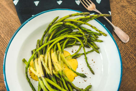 Boiled green asparagus dressed in mustard vinegar and olive oil dressing mayonnaise or hollandaise sauceの写真素材