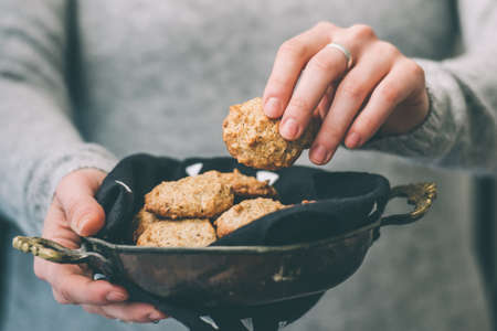 Homemade oat and nut cookies in handsの写真素材