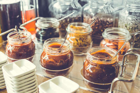 Glass jars with homemade jam. Toned imageの写真素材