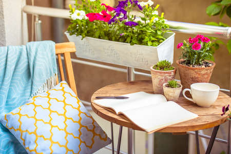 Beautiful terrace or balcony with small table, chair and flowersの写真素材