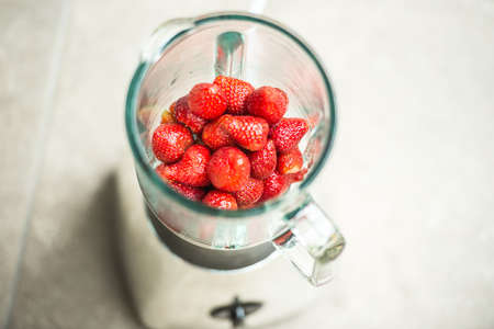 Fresh strawberries in blender cup. Selective focusの写真素材