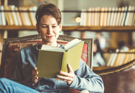 Young beautiful woman reading a book. Toned pictureの写真素材