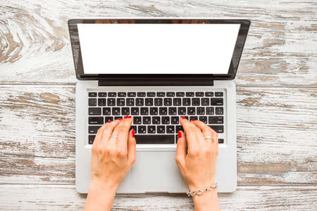 View of business woman hands busy using laptop at old wooden table. Top viewの写真素材