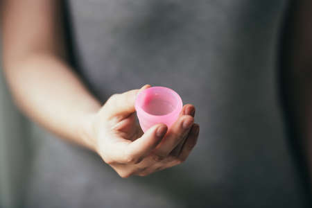 Young woman hand holding menstrual cupの写真素材