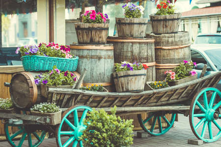 Garden flowers in different pots on old cart. Toned pictureの写真素材