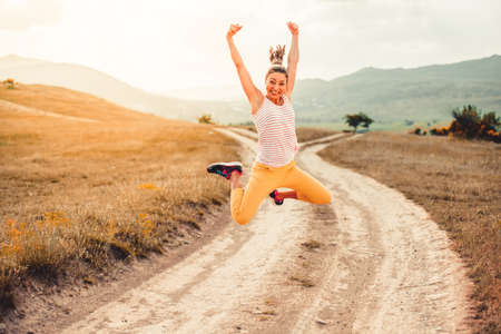 Beautiful girl jumping outdoorの写真素材