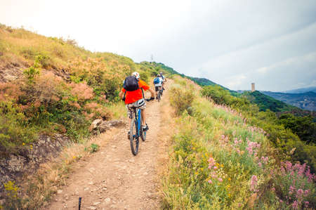 Cyclists riding mountain bike on trailの写真素材