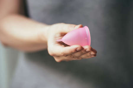 Young woman hand holding menstrual cupの写真素材