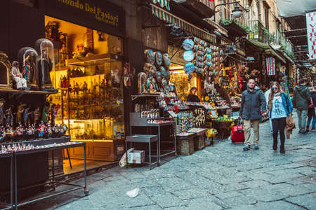 NAPLES, ITALY - MARCH 20, 2015: People walking through the old street  in the historical center of Naples, Italy. Naples is the the third-largest city in Italy with about 1 million residentsのeditorial素材