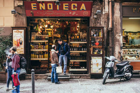 NAPLES, ITALY - MARCH 20, 2015:  Range of the wine shop on the old popular street in Naples, Italyのeditorial素材