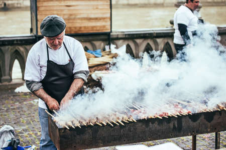 TBILISI - MAY 9, 2015 - Unidentified men prepare barbecue on the grill at the annual Young Wine Festival in Tbilisi, Georgia.のeditorial素材