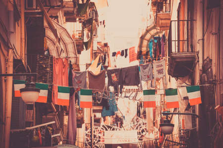 NAPLES, ITALY - MARCH 20, 2015: Classical romantic small street with italian flags in Naples, Italy. Naples is the the third-largest city in Italy with about 1 million residents. Toned pictureのeditorial素材