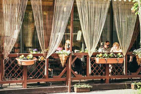 KIEV, UKRAINE - MAY 25, 2015: People eating at the outside terrace of small cafe in Kiev, Ukraine. Toned pictureのeditorial素材