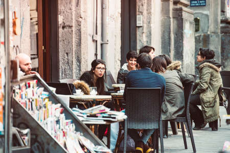 NAPLES, ITALY - MARCH 20, 2015: People eating at small cafe in Naples, Italyのeditorial素材