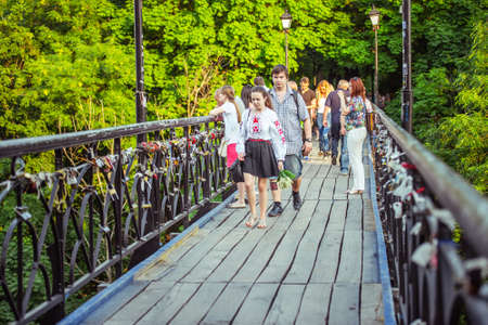 KIEV (KYIV), UKRAINE - MAY 26, 2015: People walking on the lovers bridge in Mariinsky Park in Kiev, Ukraineのeditorial素材