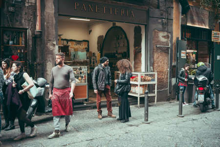 NAPLES, ITALY - MARCH 20, 2015: People walking through the old street  in the historical center of Naples, Italy. Toned pictureのeditorial素材