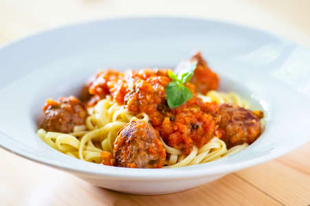 Pasta with meatballs, basil and tomato sauceの写真素材