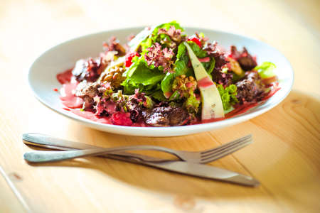 Fresh summer salad with chicken liver, blue cheese in raspberry sauceの写真素材