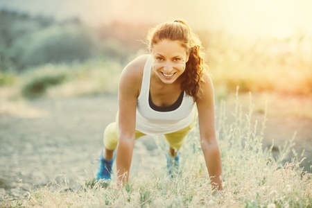 Young woman doing push ups workout. Wellness and sport concept. Toned image
