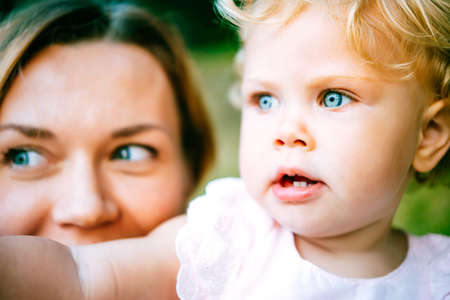Portrait of young beautiful mother and her toddler blonde daughter