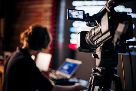 Filming creative video footage with professional video camera during the nightの写真素材