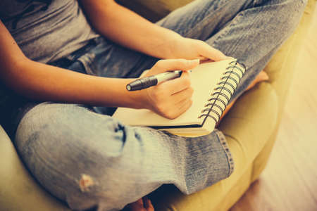 Notebook or sketchbook in hands. Creativivity, art and education concept.  Toned image