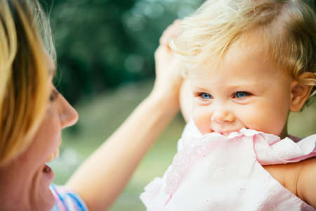 Young beautiful mother has fun with her daughterの写真素材