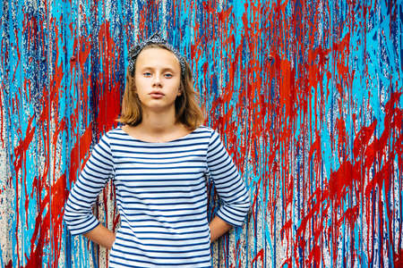 A portrait of a sad teenage girl with urban graffiti wall in the backgroundの写真素材