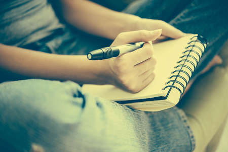 Notebook or sketchbook in hands. Creativity, art and education concept.  Toned imageの写真素材