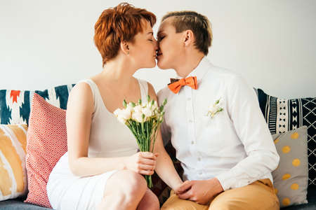 Beautiful lesbian couple kissing while celebrate their wedding. Gay marriage concept.の写真素材