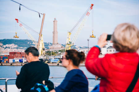 GENOA, ITALY - OCTOBER 27, 2015: Tourists enjoy the weather and take pictures in Porto Antico in Genoa, Italy.のeditorial素材