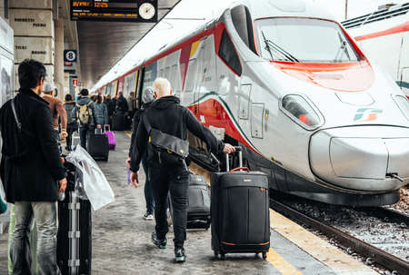 VENICE, ITALY - OCTOBER 14, 2015: Passengers walk along the trains at St. Lucia railway station in Venice, Italy.のeditorial素材