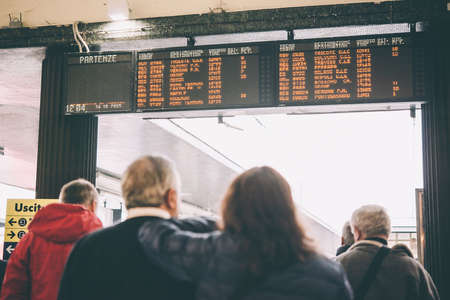 VENICE, ITALY - OCTOBER 14, 2015: Passengers watch the timetable at St. Lucia railway station in Venice, Italy. Toned pictureのeditorial素材
