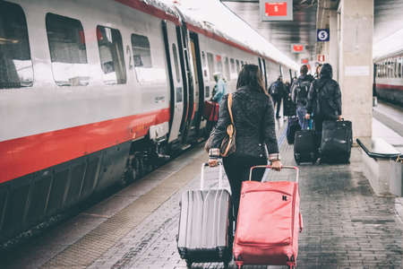 VENICE, ITALY - OCTOBER 14, 2015: Passengers walk along the trains at St. Lucia railway station in Venice, Italy.のeditorial素材