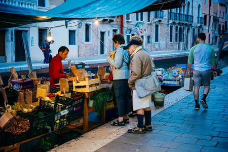 VENICE, ITALY - OCTOBER 12, 2015: A small local evening market in one of the streets in Venice, Italy.のeditorial素材