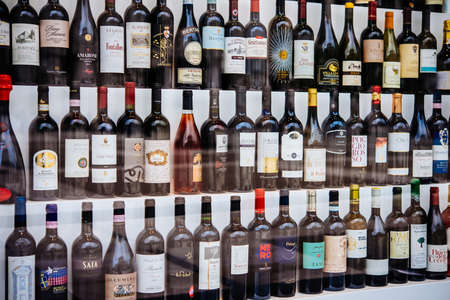 MILANO, ITALY - OCTOBER 14, 2015: Different kinds of italian wines on display in a shop window in Milano, Italy.のeditorial素材