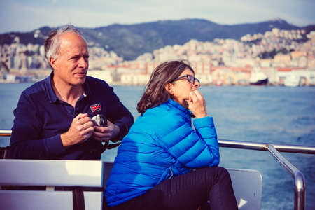 GENOA, ITALY - OCTOBER 27, 2015: Tourists enjoy the weather and take pictures in Porto Antico in Genoa, Italy. Toned imageのeditorial素材