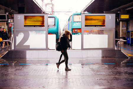 VENICE, ITALY - OCTOBER 14, 2015: Passengers walk along the trains at St. Lucia railway station in...