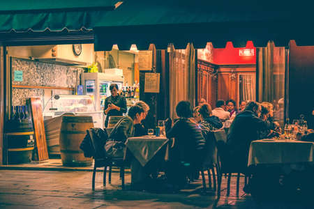 VENICE, ITALY - OCTOBER 11: People are sitting at the outside terrace of a small cafe in the evening in Venice, Italy. Toned pictureのeditorial素材