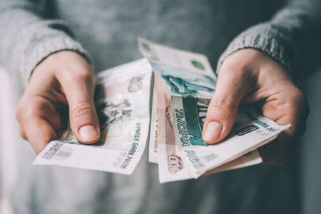 Hands holding russian rouble bills. Toned pictureの写真素材