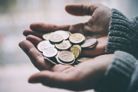 Hands holding russian rouble coins in hands. Toned picture
