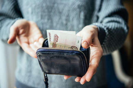 Hands holding russian rouble bills and small money pouchの写真素材